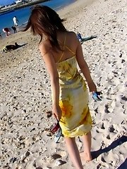 Cute Asian model likes posing on the beach