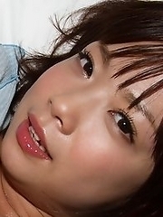 Cute and sexy Japanese av idol Mana Sakura lies on bed showing off her lovely breasts