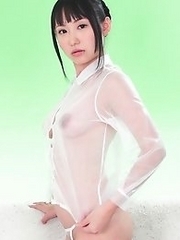 On the green screen Reina ran her hands across her see through outfit