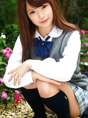 Manami Sato in short uniform skirt spends time in the park