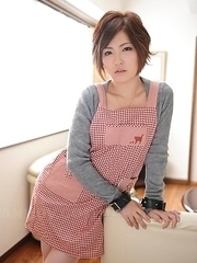 Kaede Oshiro with busy mouth shows sexy legs